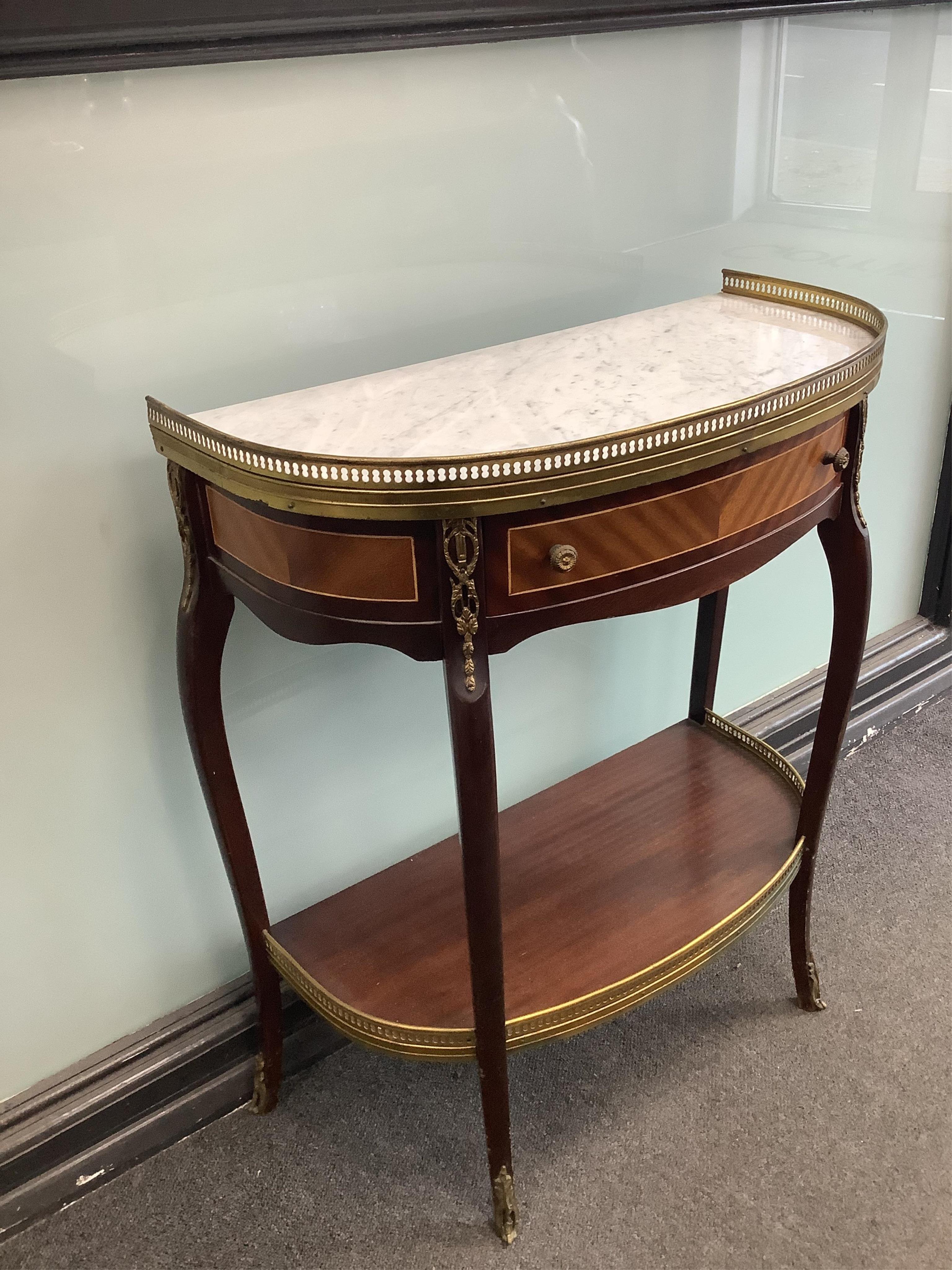 A Louis XVI style gilt metal mounted mahogany two tier marble top side table, width 62cm, depth 31cm, height 73cm. Condition- good